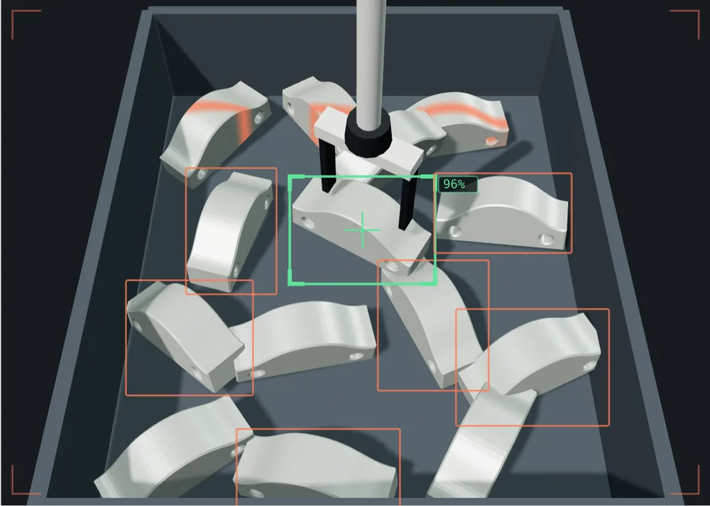 Quello che vede la telecamera del robot: un cassone di staffe metalliche alla rinfusa, inquadrato dall'alto. Il software ha segnato con un riquadro i pezzi che riconosce, e con un mirino verde quello scelto per la presa, dove sta scendendo la pinza.